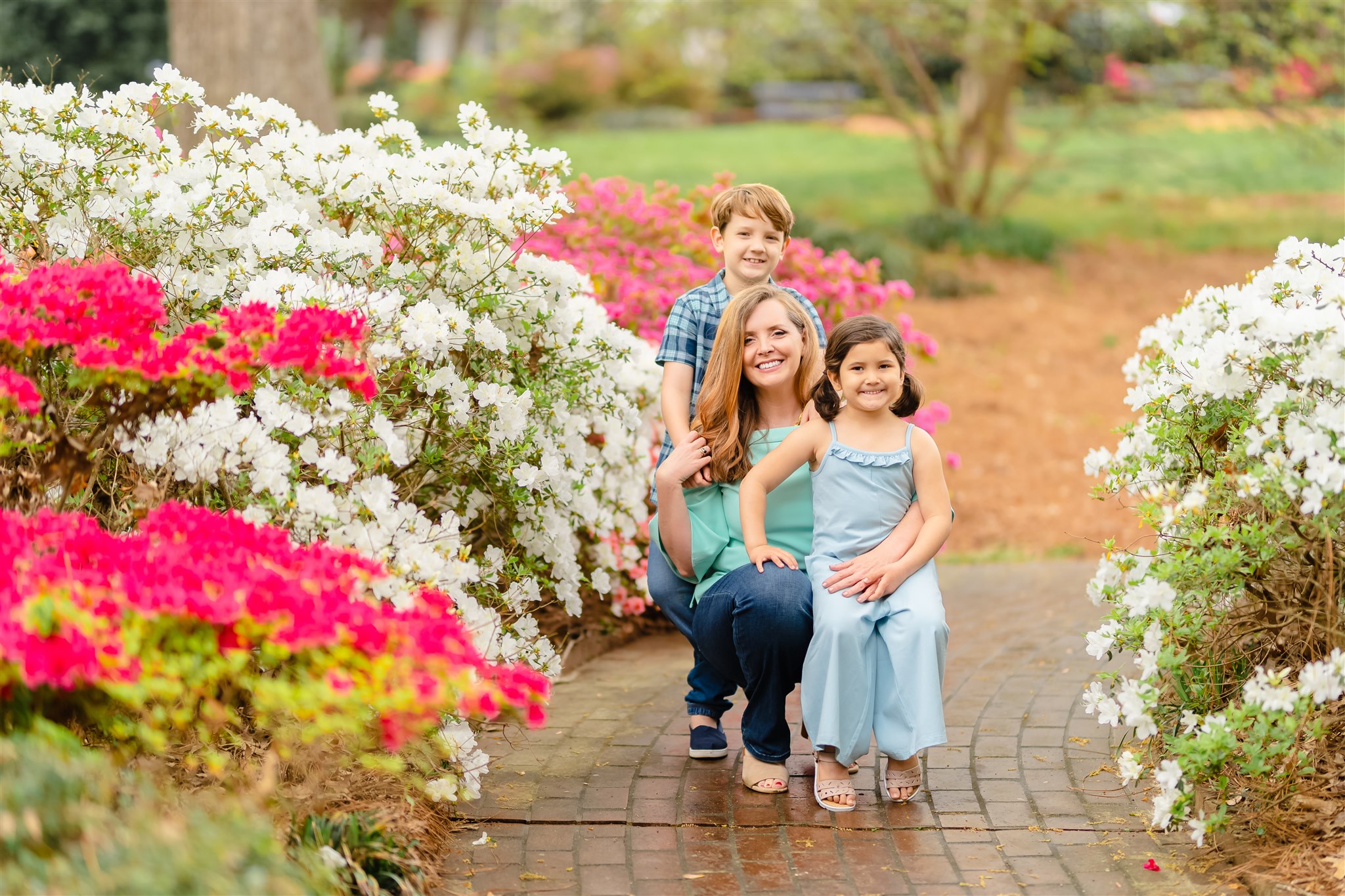 charlotte family photo with family of three on garden path